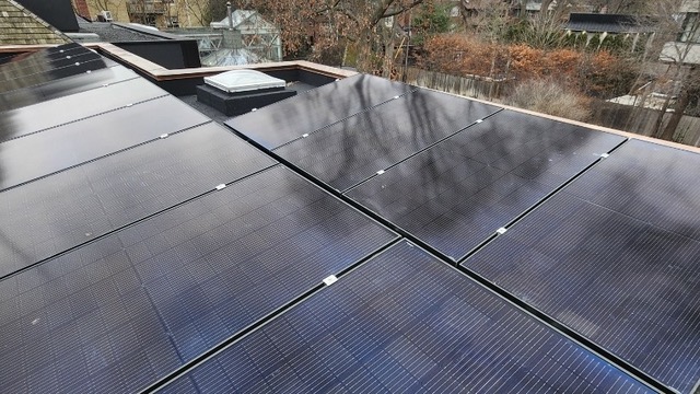 Rooftop view of a home, looking over the solar panels.
