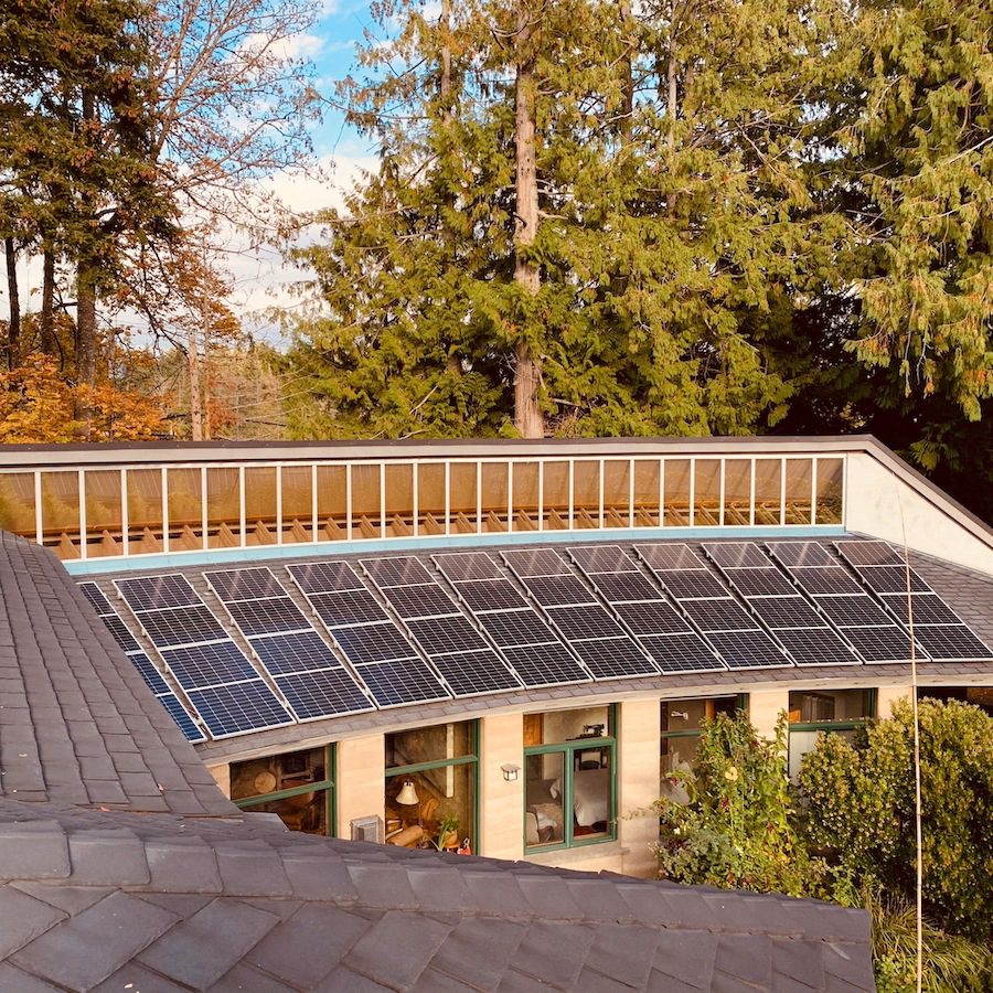Solar installation on a unique building with a curved roof.